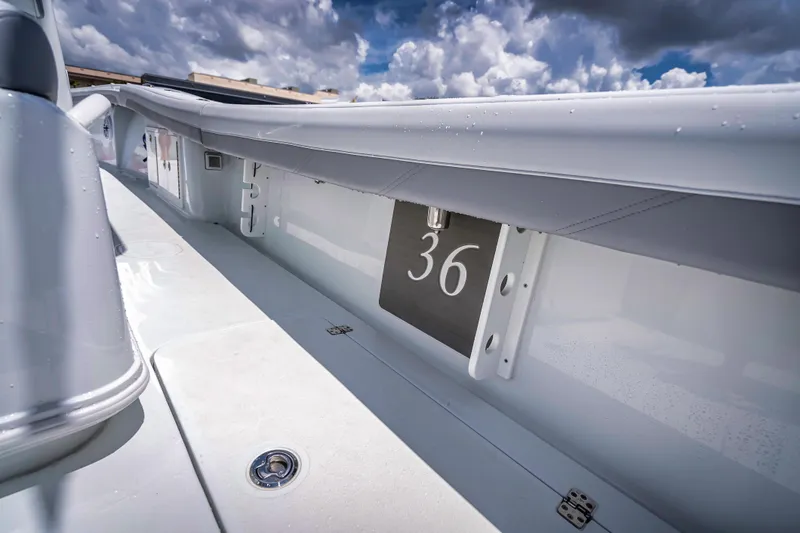 Slide: The Image of 2025 Yellowfin 36 Offshore boat deck with sleek design under cloudy sky. - 36