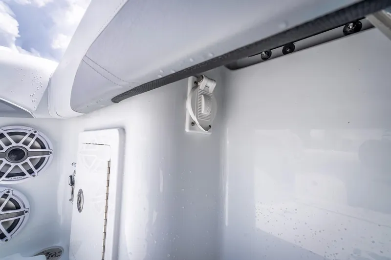 Slide: The Image of 2025 Yellowfin 36 Offshore boat interior with speakers and storage compartment. - 37