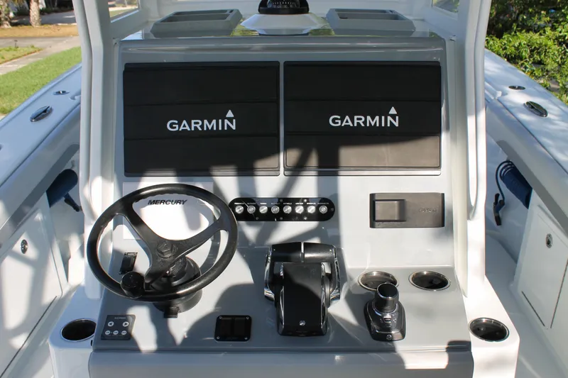 Slide: The Image of 2025 Yellowfin 36 Offshore boat helm with Garmin displays and Mercury steering wheel. - 4