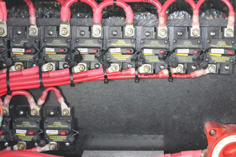 Slide: The Image of Electrical panel with circuit breakers and red wires on a 2025 Yellowfin 36 Offshore boat. - 41