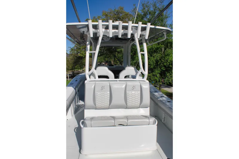 Slide: The Image of 2025 Yellowfin 36 Offshore boat interior with cushioned seating and rod holders. - 5