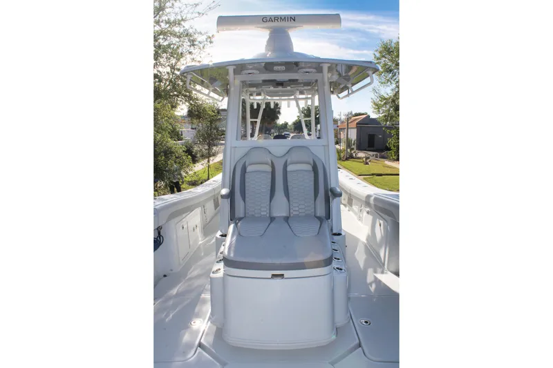 Slide: The Image of 2025 Yellowfin 36 Offshore boat interior with seating and Garmin equipment. - 7