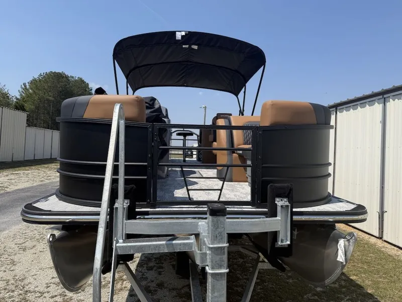 Slide: The Image of 2026 Sylvan L-3 LZ DH pontoon boat with black canopy and brown seats. - 2