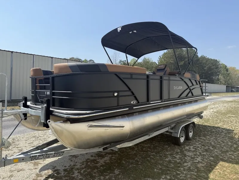 Slide: The Image of 2026 Sylvan L-3 LZ DH pontoon boat on trailer outdoors. - 5