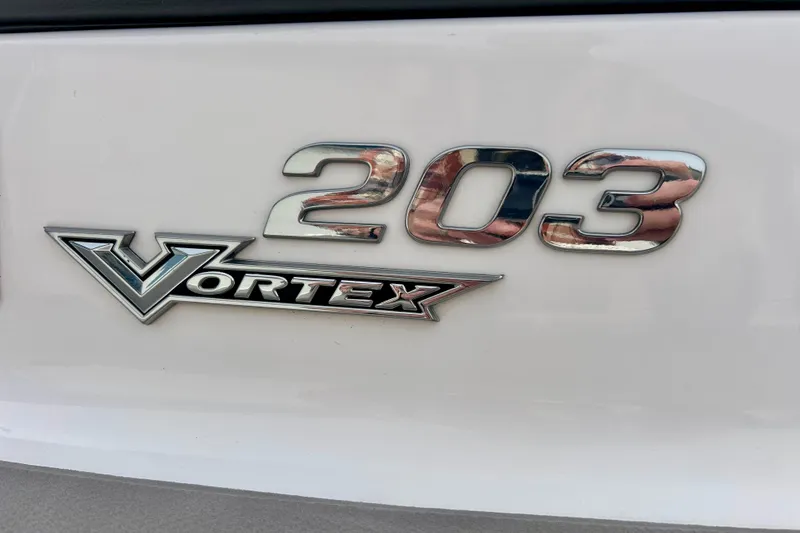 Slide: The Image of Chrome emblem of 2017 Chaparral 203 Vortex boat on white surface. - 10