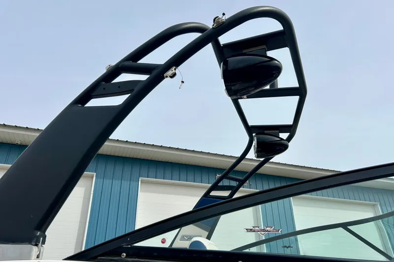 Slide: The Image of 2017 Chaparral 203 Vortex boat tower against blue sky and building background. - 16