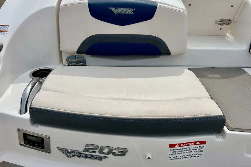 Slide: The Image of 2017 Chaparral 203 Vortex boat seating area with VRX branding and safety warning. - 22