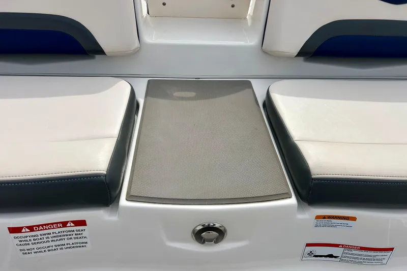 Slide: The Image of 2017 Chaparral 203 Vortex swim platform with cushioned seating and safety warnings. - 23