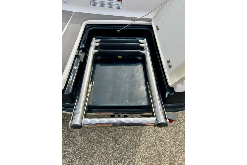 Slide: The Image of 2017 Chaparral 203 Vortex boat ladder, stainless steel, folded in storage compartment. - 27