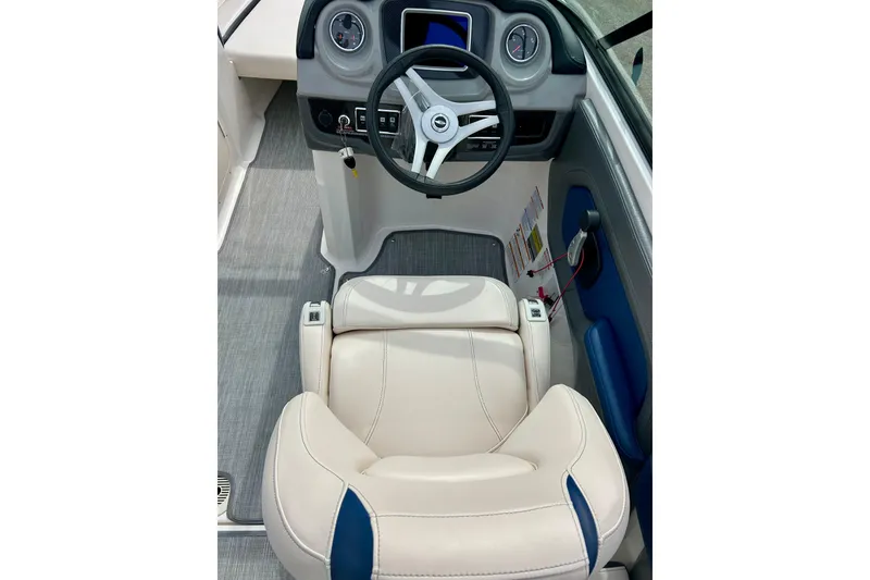 Slide: The Image of Interior of 2017 Chaparral 203 Vortex boat with steering wheel and beige seating. - 33
