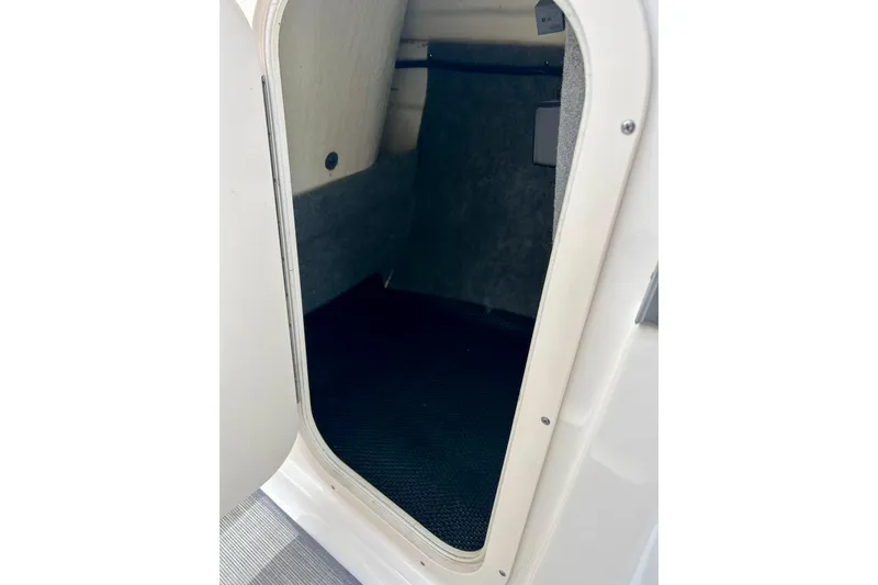 Slide: The Image of Storage compartment inside 2017 Chaparral 203 Vortex boat, featuring carpeted interior. - 38