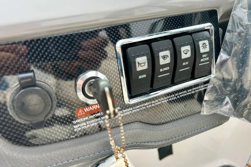 Slide: The Image of Control panel of a 2017 Chaparral 203 Vortex boat with switches and ignition key. - 40