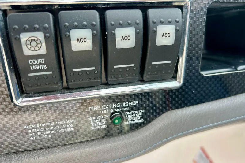 Slide: The Image of Dashboard switches of a 2017 Chaparral 203 Vortex boat, including court lights and accessories. - 43