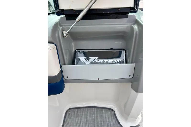 Slide: The Image of 2017 Chaparral 203 Vortex boat interior with storage compartment and logo. - 47