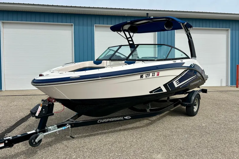 Slide: The Image of 2017 Chaparral 203 Vortex boat on trailer, parked outside blue building. - 5