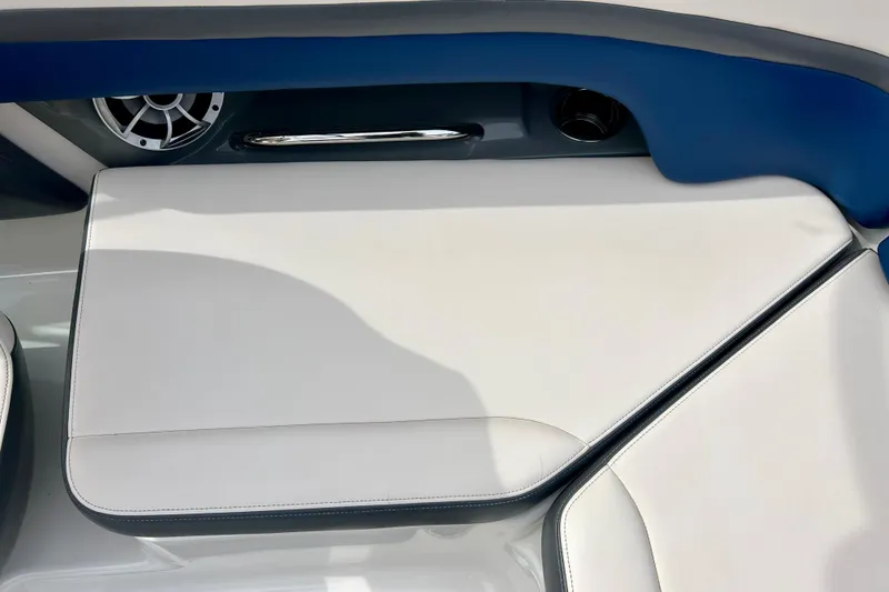 Slide: The Image of 2017 Chaparral 203 Vortex boat interior with white cushioned seating and speaker detail. - 51