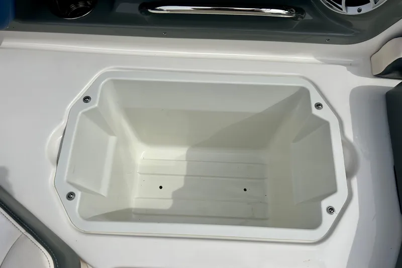 Slide: The Image of Storage compartment in 2017 Chaparral 203 Vortex boat, featuring a sleek white interior. - 60
