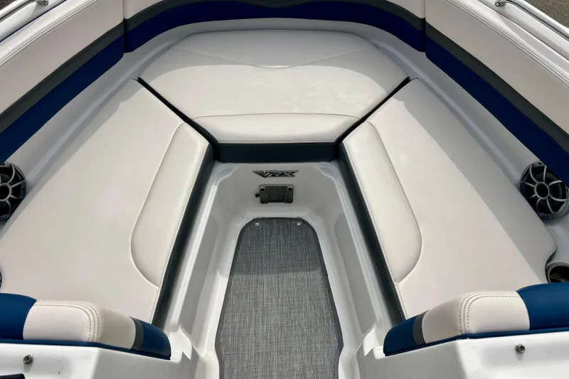 Slide: The Image of Interior seating of a 2017 Chaparral 203 Vortex boat with white and blue upholstery. - 62