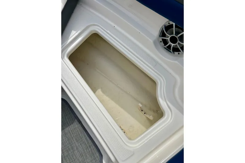 Slide: The Image of Storage compartment in 2017 Chaparral 203 Vortex boat, featuring a speaker nearby. - 65