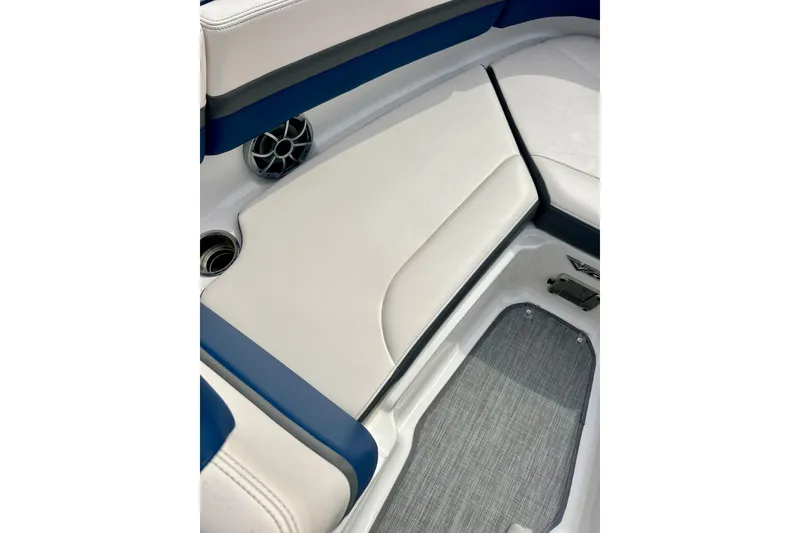 Slide: The Image of 2017 Chaparral 203 Vortex boat interior with white and blue seating, speaker, and flooring. - 66