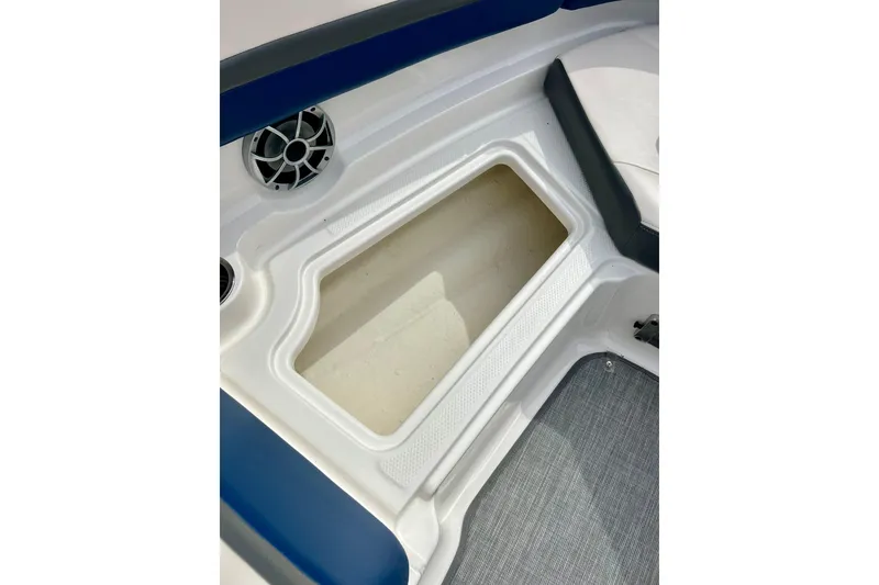 Slide: The Image of 2017 Chaparral 203 Vortex boat interior storage compartment with speaker detail. - 67