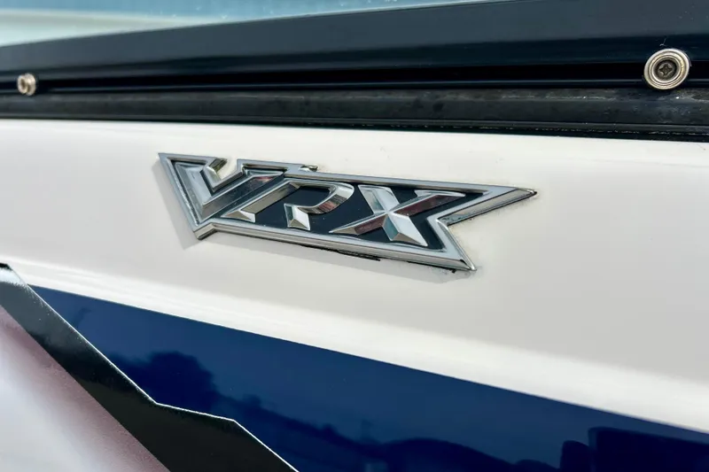 Slide: The Image of 2017 Chaparral 203 Vortex boat emblem, featuring "VRX" logo on white and blue surface. - 78