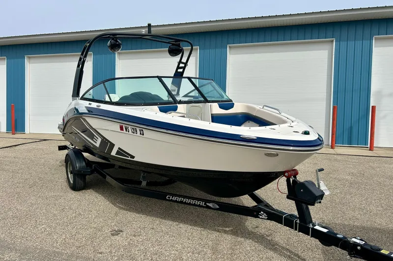 Slide: The Image of 2017 Chaparral 203 Vortex boat on trailer, parked near blue storage units. - 9