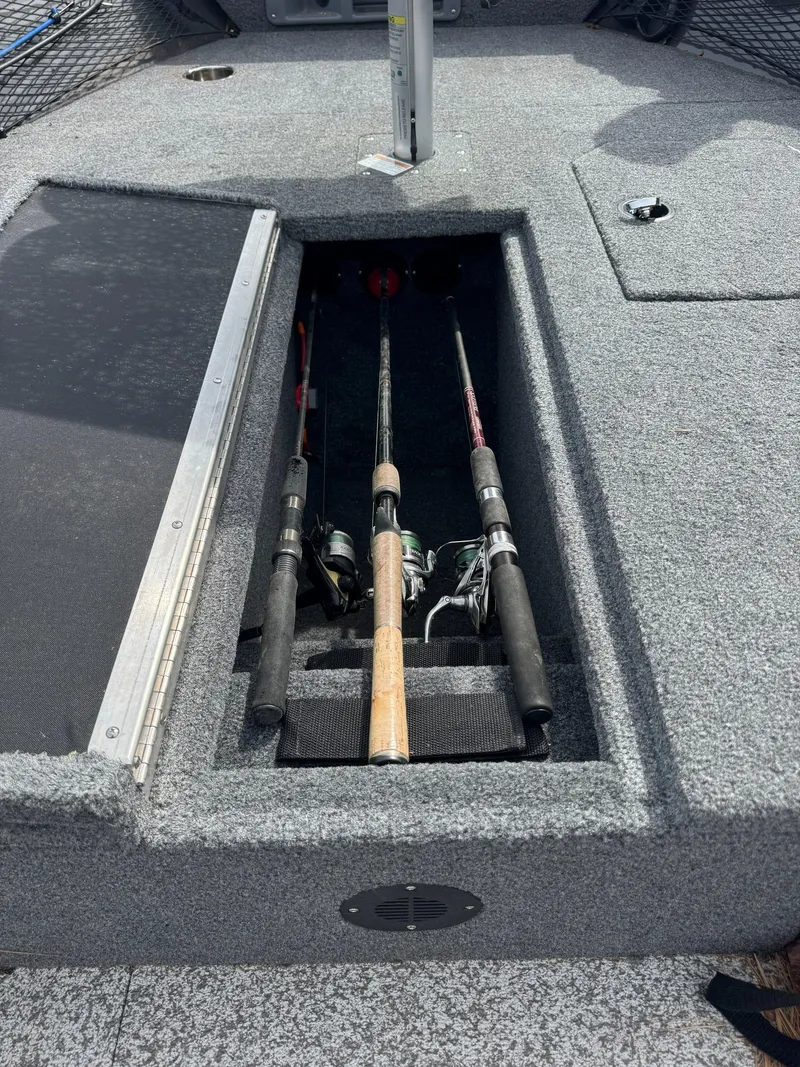 Slide: The Image of Fishing rod compartment on a 2024 MirroCraft 1686 boat. - 11