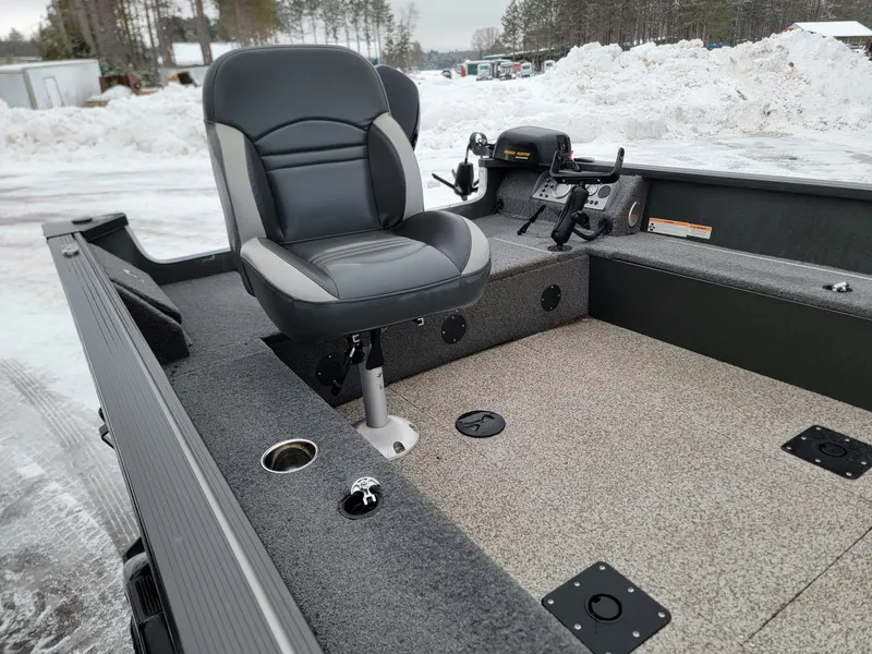 Slide: The Image of 2024 MirroCraft 1686 boat with seat and controls in snowy setting. - 7