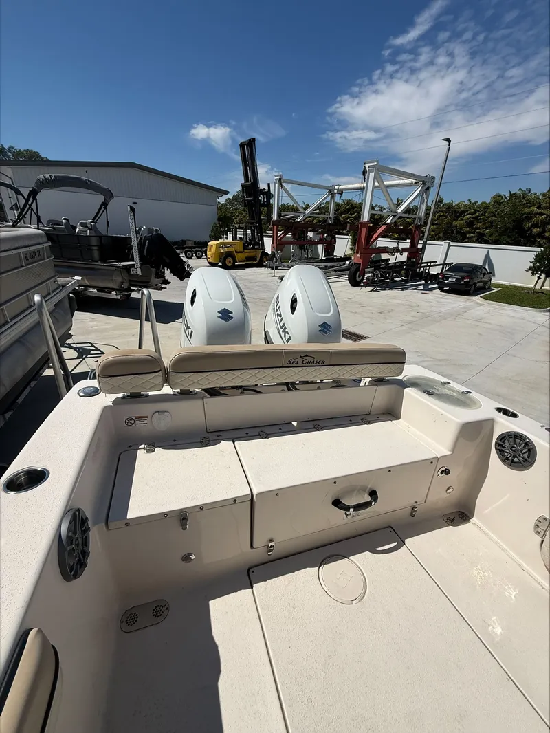 Slide: The Image of 2023 Sea Chaser 24 HFC boat with dual engines outdoors. - 14