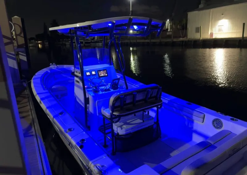 Slide: The Image of 2023 Sea Chaser 24 HFC boat at night with blue lighting. - 4