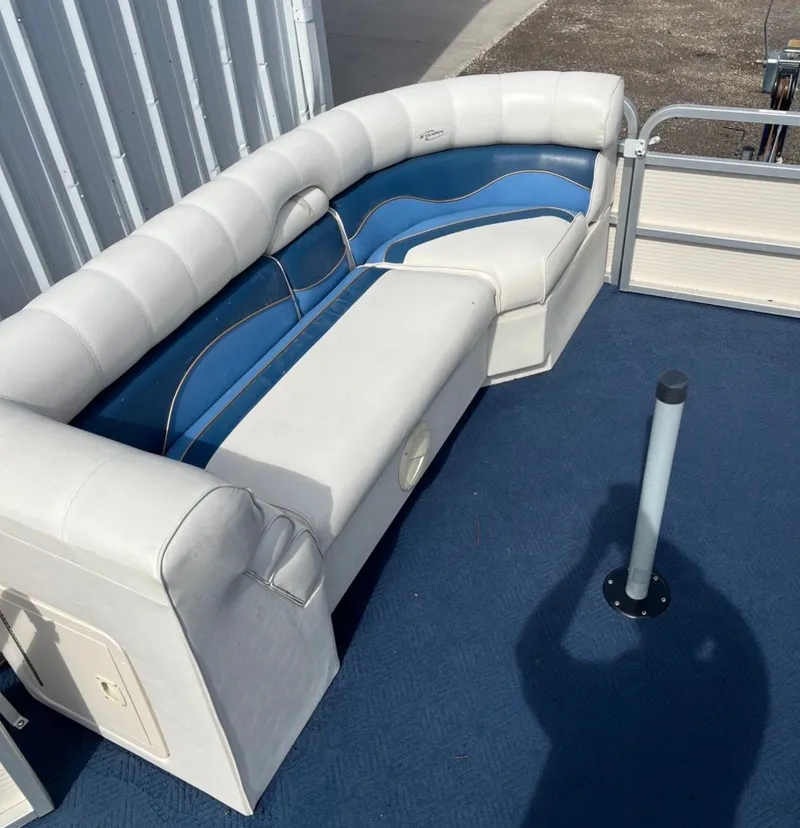 Slide: The Image of Interior of a 2001 Sylvan 8526 Capri boat with blue and white seating. - 9