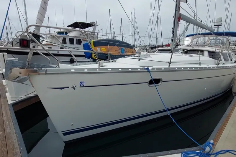 The Image of 2002 Jeanneau Sun Odyssey 43 DS sailboat docked in a marina, side view. - 0
