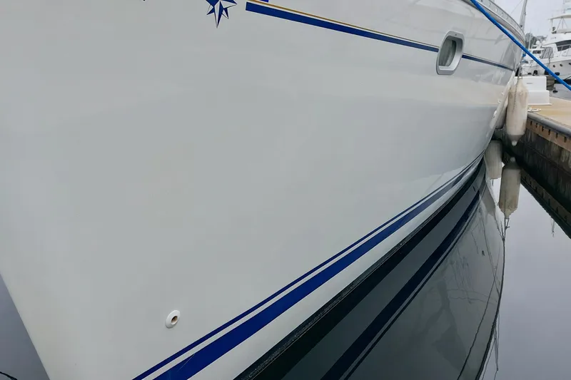 Slide: The Image of Side view of a 2002 Jeanneau Sun Odyssey 43 DS yacht docked at a marina. - 15