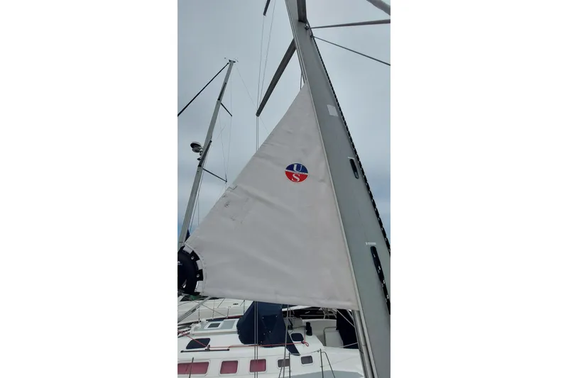 Slide: The Image of Sail of a 2002 Jeanneau Sun Odyssey 43 DS yacht against a cloudy sky. - 23