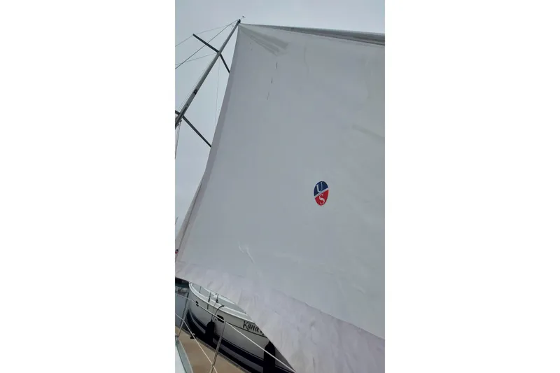 Slide: The Image of Sail of a 2002 Jeanneau Sun Odyssey 43 DS yacht, docked at a marina. - 24
