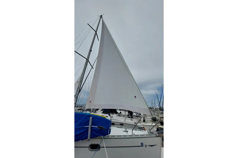 Slide: The Image of Sailboat Jeanneau Sun Odyssey 43 DS, 2002 model, docked with sails raised. - 25