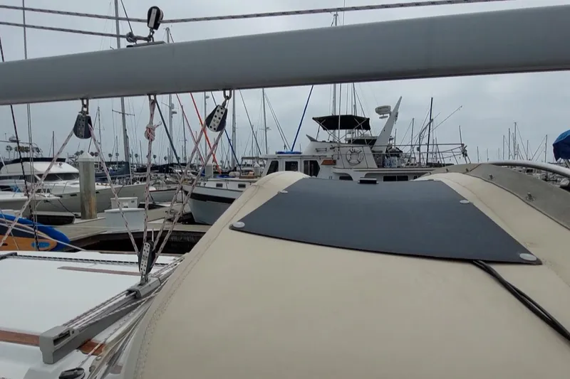 Slide: The Image of 2002 Jeanneau Sun Odyssey 43 DS sailboat docked in a marina, surrounded by other boats. - 28