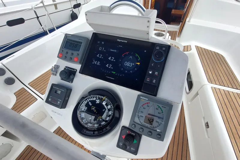 Slide: The Image of Cockpit of 2002 Jeanneau Sun Odyssey 43 DS with navigation instruments and compass. - 31