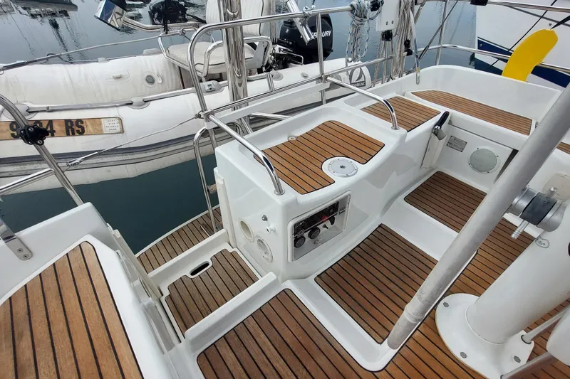 Slide: The Image of Cockpit of 2002 Jeanneau Sun Odyssey 43 DS with teak flooring and control panel. - 33