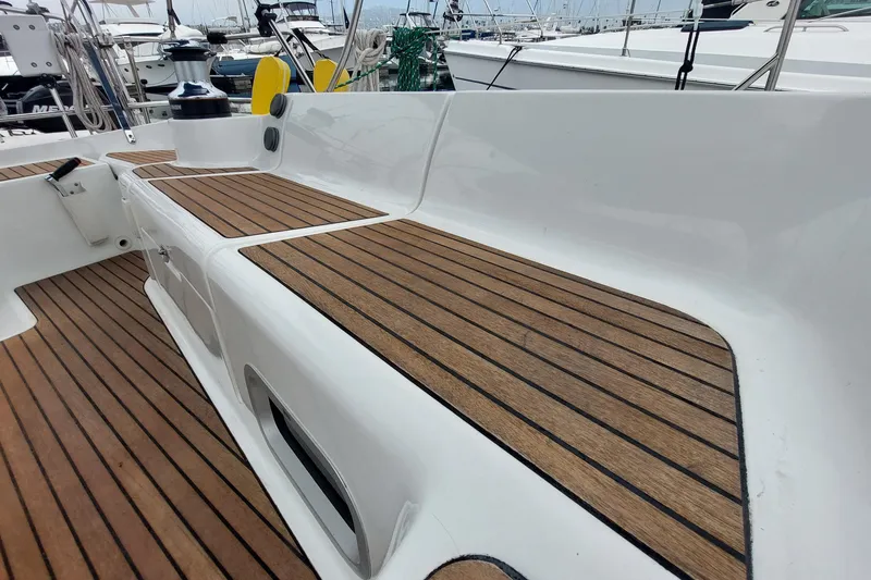 Slide: The Image of Teak deck of 2002 Jeanneau Sun Odyssey 43 DS sailboat in marina setting. - 34