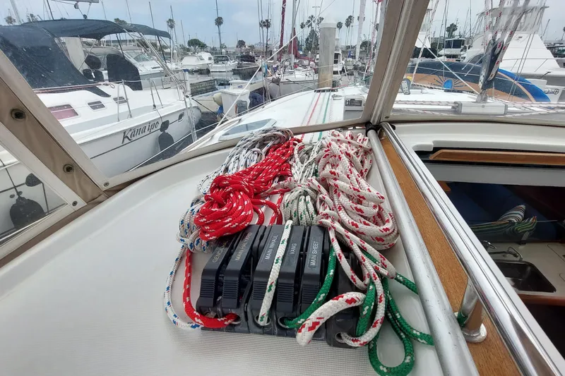 Slide: The Image of Jeanneau Sun Odyssey 43 DS sailboat deck with ropes and winches, docked at marina. - 40