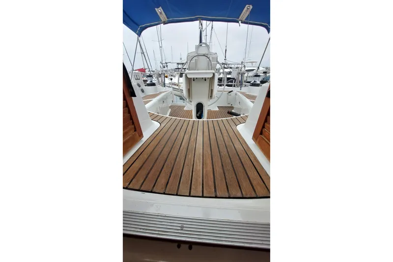 Slide: The Image of 2002 Jeanneau Sun Odyssey 43 DS sailboat with teak deck and blue canopy. - 43