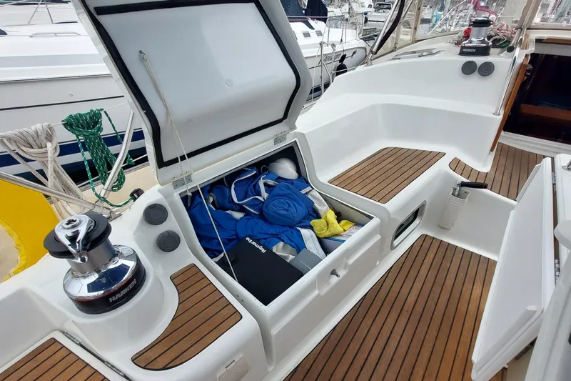 Slide: The Image of Cockpit storage of 2002 Jeanneau Sun Odyssey 43 DS sailboat with open hatch and gear. - 46