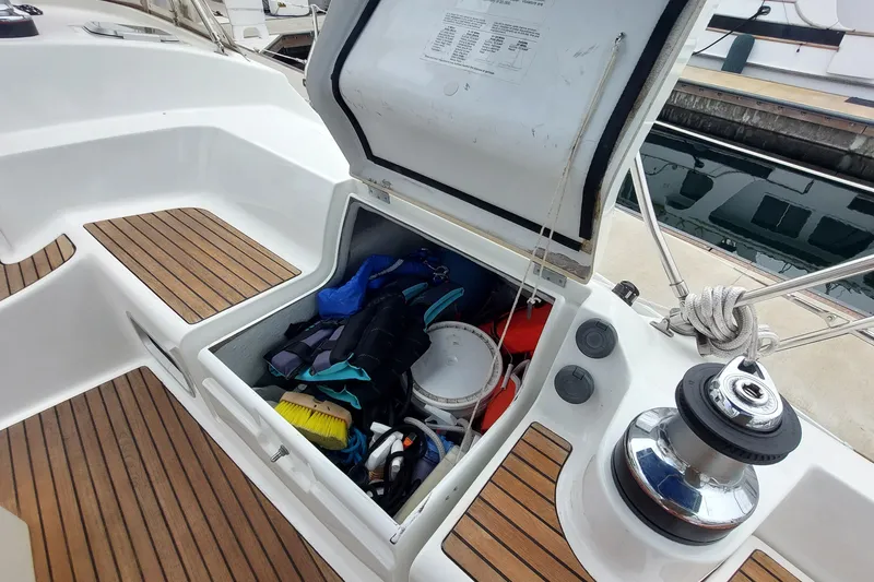 Slide: The Image of Open storage compartment on 2002 Jeanneau Sun Odyssey 43 DS sailboat, filled with boating gear. - 47