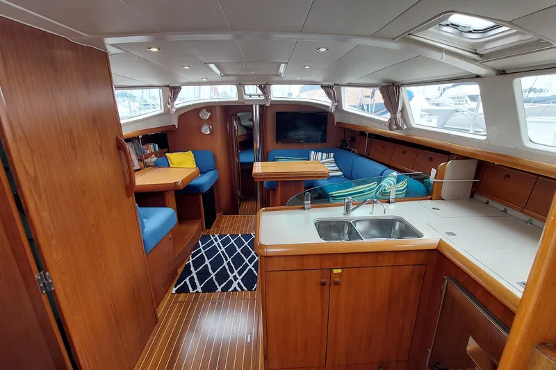 Slide: The Image of Interior of 2002 Jeanneau Sun Odyssey 43 DS yacht with wood finish and blue seating. - 48