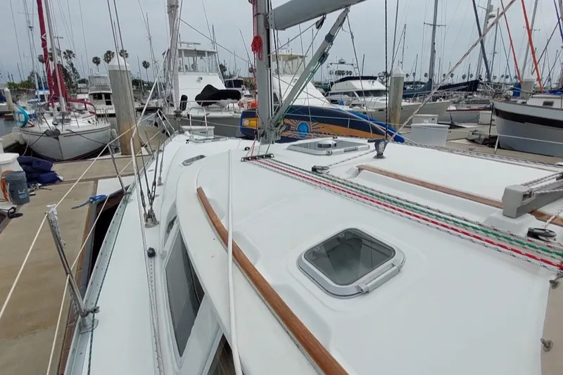 Slide: The Image of Jeanneau Sun Odyssey 43 DS sailboat docked in marina, 2002 model, white deck, rigging visible. - 5