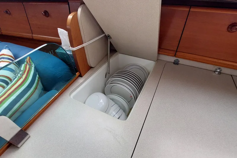 Slide: The Image of Hidden storage compartment with dishes on Jeanneau Sun Odyssey 43 DS yacht, 2002 model. - 53