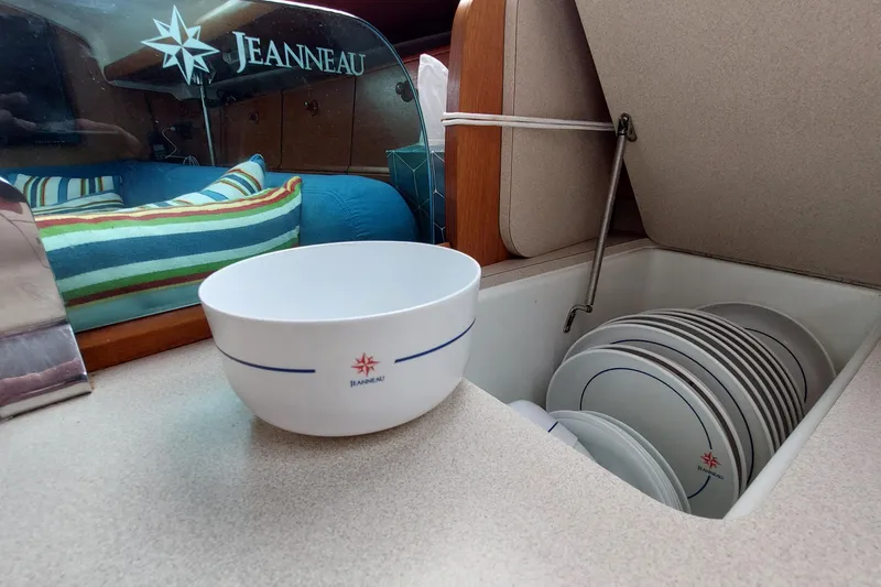 Slide: The Image of Jeanneau Sun Odyssey 43 DS 2002 yacht interior with branded dishware and cozy seating. - 54