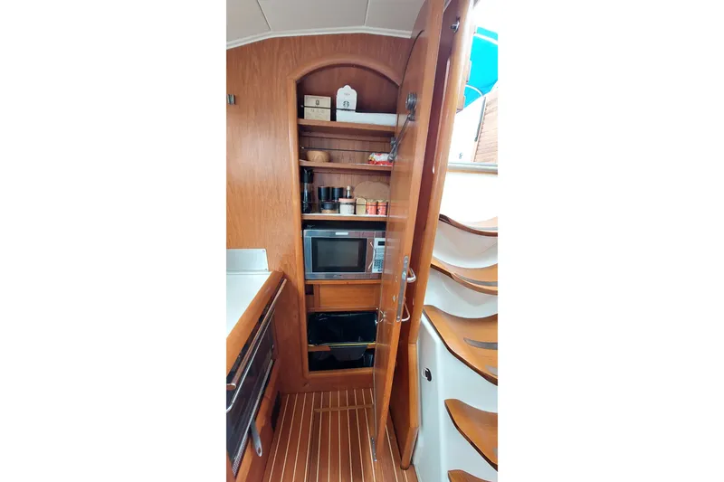 Slide: The Image of Interior of 2002 Jeanneau Sun Odyssey 43 DS yacht with wooden cabinetry and microwave. - 57